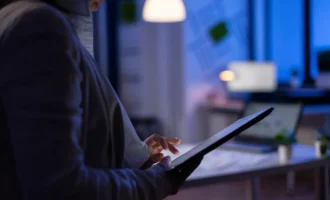 close-up-woman-hands-typing-tablet-checking-financial-graphs-standing-start-up-office-late-night