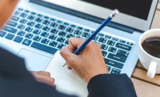 cropped-hand-writing-book-cafe